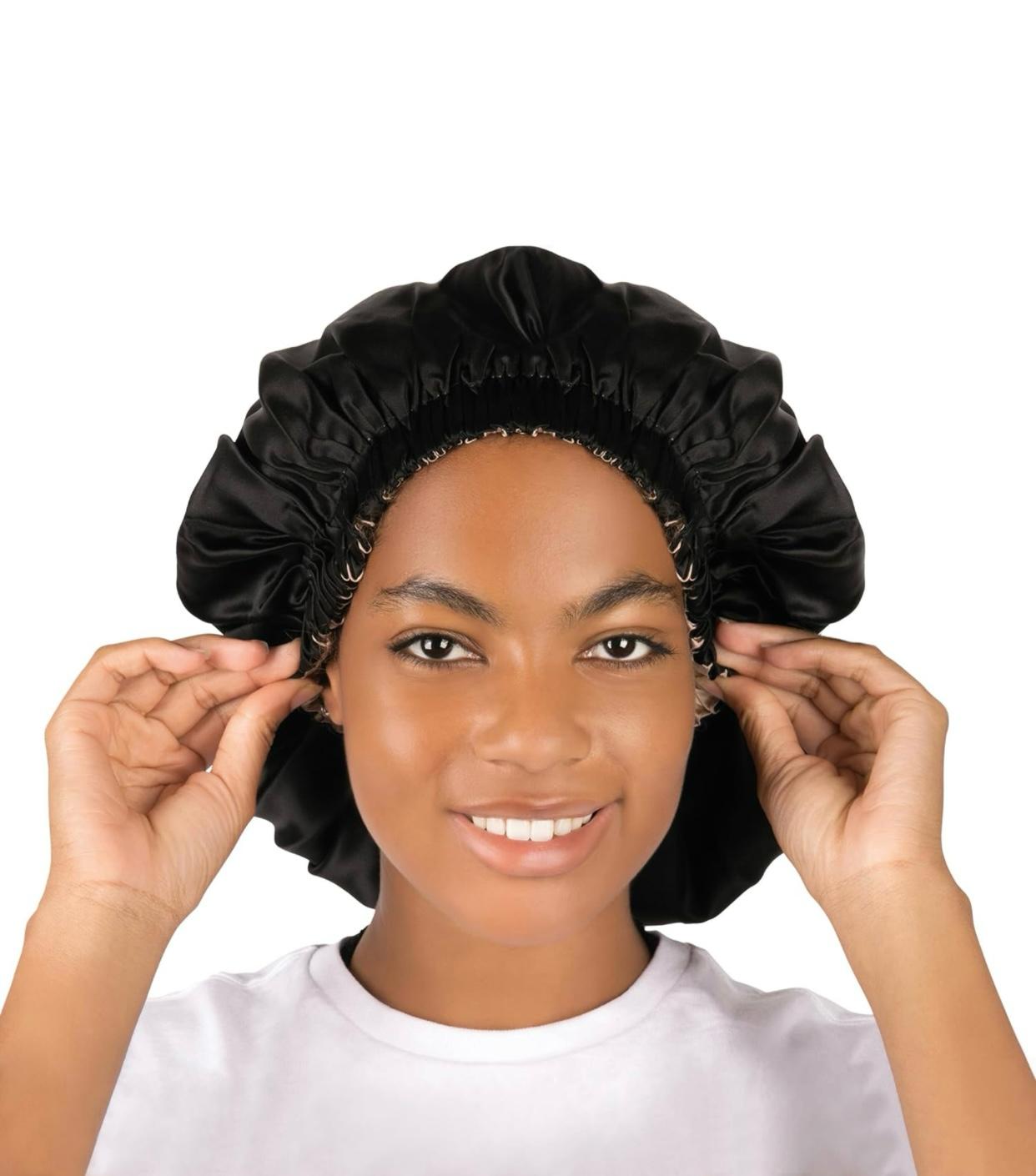 Champagne silk bonnet resting on ivory silk fabric